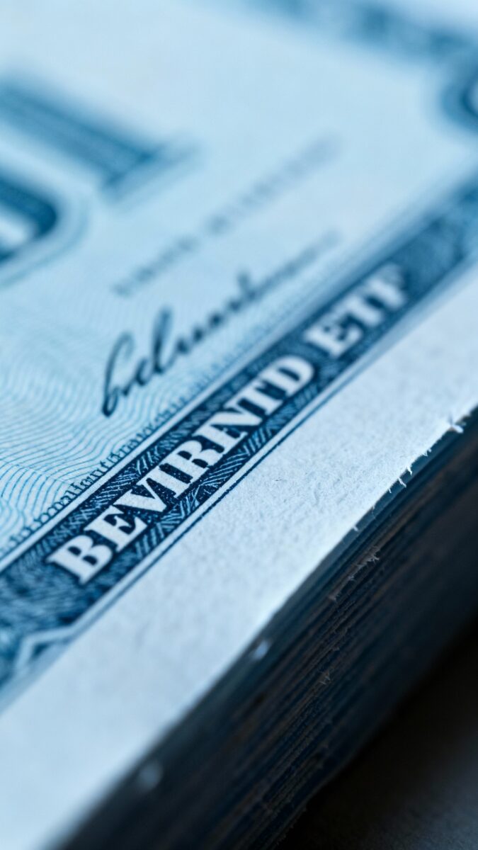 Macro shot of dividend ETF stock certificate texture, crisp paper edges, muted blue