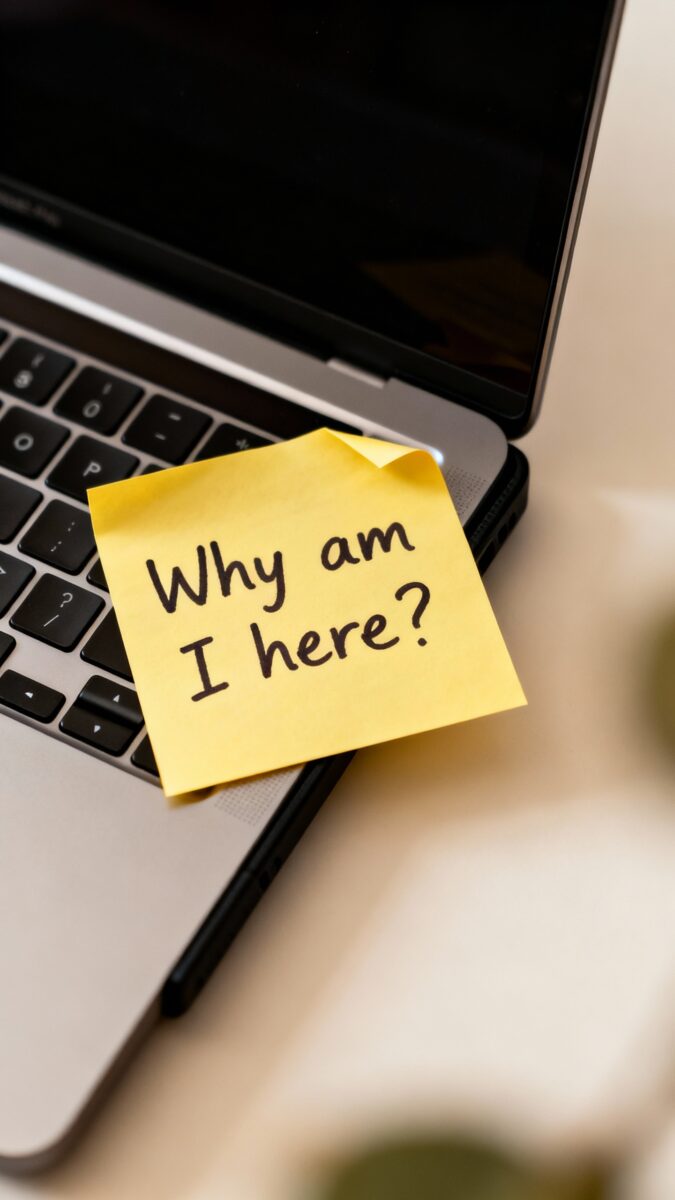 sticky note “Why am I here?” on laptop bezel